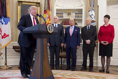 US President Donald Trump, alongside US Vice President Mike Pence (2nd L), Commerce Secretary Wilbur Ross (C) and Peter Navarro (2nd R), director of the National Trade Council, speaks about signing executive orders on trade policies in the Oval Office of the White House in Washington, DC, March 31, 2017. / AFP PHOTO / SAUL LOEB        (Photo credit should read SAUL LOEB/AFP/Getty Images)
