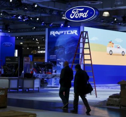People walk near the Ford exhibit area of the New York International Auto Show at the Javits Center ahead of the event in New York March 30, 2015.
REUTERS/Shannon Stapleton