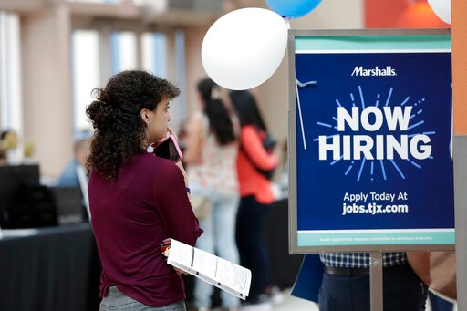 FILE - In this Oct. 1, 2019, file photo, Daisy Ronco waits in line to apply for a job with Marshalls during a job fair at Dolphin Mall in Miami. (AP Photo/Lynne Sladky, File)