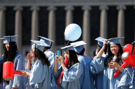 Graduates find their seats during the Columbia University graduation ceremony in New York, Wednesday, May 17, 2017. Over 14,000 students graduated during the ceremonies. (AP Photo/Seth Wenig)