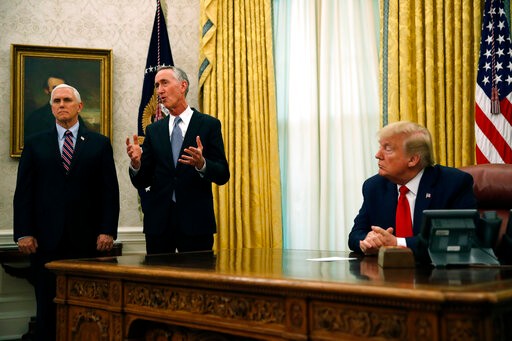 Daniel O'Day, CEO of Gillead Sciences Inc., speaks during a meeting with President Donald Trump in the Oval Office of the White House, Friday, May 1, 2020, in Washington, as Vice President Mike Pence watches. U.S. regulators are allowing emergency use of first drug shown to help coronavirus patients that is made by Gillead. (AP Photo/Alex Brandon)