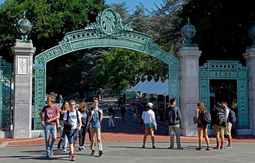 FILE - In this April 21, 2017, file photo, students walk past Sather Gate on the University of California, Berkeley campus in Berkeley, Calif. Students are continuing to apply to the University of California system in record numbers for the 13th straight year. Preliminary data released by the UC system Thursday, Dec. 14, 2017, shows nearly 222,000 prospective undergraduates applied for at least one UC school for the fall of 2018 during the application period that ended Nov. 30. (AP Photo/Ben Margot, File)