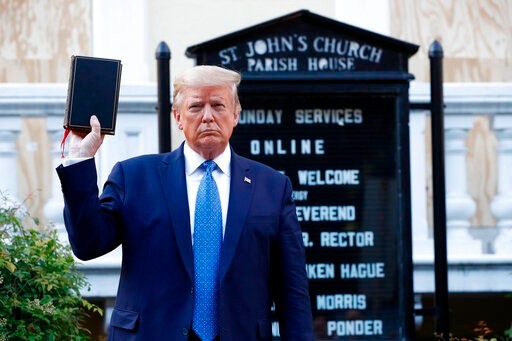 President Donald Trump holds a Bible as he visits outside St. John's Church across Lafayette Park from the White House Monday, June 1, 2020, in Washington. Park of the church was set on fire during protests on Sunday night. (AP Photo/Patrick Semansky)