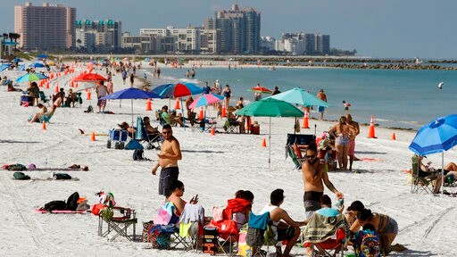 Cones are set up to help beachgoers keep a safe distance from one another after Clearwater Beach officially reopened to the public Monday, May 4, 2020, in Clearwater Beach, Fla. Many public beaches and restaurants are reopening as part of Florida Gov. Ron DeSantis' plan to stop the spread of the coronavirus. (AP Photo/Chris O'Meara)