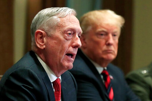 FILE - In this Oct. 23, 2018 file photo, Defense Secretary Jim Mattis speaks beside President Donald Trump, during a briefing with senior military leaders in the Cabinet Room at the White House in Washington. In Trump’s America, is anyone listening to the conservative wise men who damn him with faint, coded criticism? (AP Photo/Manuel Balce Ceneta, File)
