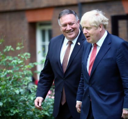 Britain's Prime Minister Boris Johnson, right, welcomes the United States Secretary of State, Mike Pompeo to Downing Street, London, Tuesday July 21, 2020, ahead of a private meeting. Pompeo is to meet with British Prime Minister Boris Johnson and Foreign Secretary Domnic Raab just hours after Britain suspended its extradition treaty with Hong Kong and blocked arms sales to the former British territory after China imposed a tough new national security law. (Hannah McKay/Pool via AP)