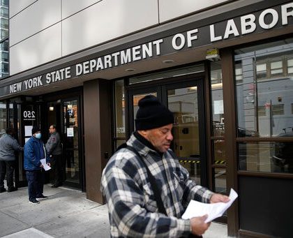 Visitors to the Department of Labor are turned away at the door by personnel due to closures over coronavirus concerns, Wednesday, March 18, 2020, in New York. Applications for jobless benefits are surging in some states as coronavirus concerns shake the U.S. economy. The sharp increase comes as governments have ordered millions of workers, students and shoppers to stay home as a precaution against spreading the virus that causes the COVID-19 disease.  (AP Photo/John Minchillo)