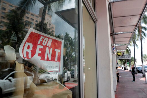 A For Rent sign hangs on a closed shop during the coronavirus pandemic, Monday, July 13, 2020, in Miami Beach, Fla. (AP Photo/Lynne Sladky)