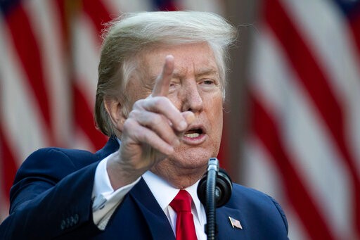 President Donald Trump points to a question as he speaks about the coronavirus in the Rose Garden of the White House, Monday, April 27, 2020, in Washington. (AP Photo/Alex Brandon)