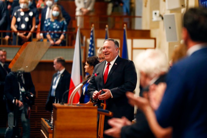 U.S. Secretary of State Mike Pompeo, center, smiles as he arrives for a meeting of the senate in Prague, Czech Republic, Wednesday, Aug. 12, 2020. U.S. Secretary of State Mike Pompeo is in Czech Republic at the start of a four-nation tour of Europe. Slovenia, Austria and Poland are the other stations of the trip. (AP Photo/Petr David Josek, Pool)
