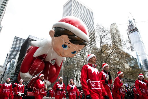 The Elf on the Shelf balloon makes its way down New York's Sixth Avenue during the Macy's Thanksgiving Day Parade, Thursday, Nov. 28, 2019, in New York. (AP Photo/Jeenah Moon)