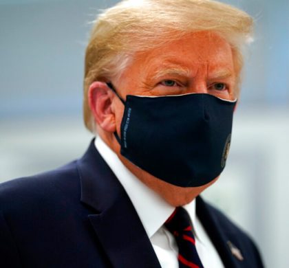 In this July 27, 2020, file photo, President Donald Trump wears a face mask as he participates in a tour of Bioprocess Innovation Center at Fujifilm Diosynth Biotechnologies in Morrisville, N.C. President Donald Trump and first lady Melania Trump have tested positive for the coronavirus, the president tweeted early Friday. (AP Photo/Evan Vucci, File)