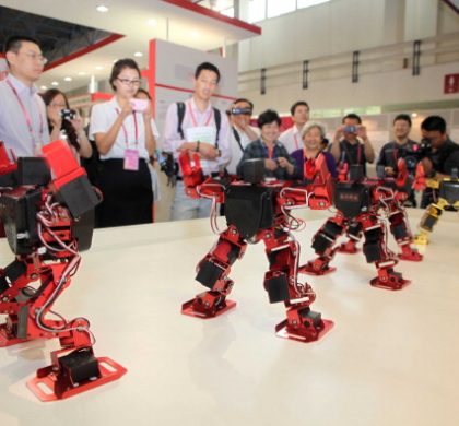 BEIJING, CHINA - MAY 18:  (CHINA OUT) People look at dancing robots during the 14th China Beijing International High-tech Expo (CHITEC) at the China International Exhibition Center on May 18, 2011 in Beijing, China. The 14th CHITEC will be held in Beijing from May 17th to 22nd, 2011, with the theme of "innovation driving development, science and technology leading transformation".  (Photo by ChinaFotoPress/Getty Images)