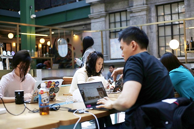 "Chinese employees work at a WeWork co-working space in Shanghai, China, 28 February 2017."