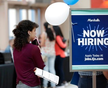 FILE - In this Oct. 1, 2019, file photo, Daisy Ronco waits in line to apply for a job with Marshalls during a job fair at Dolphin Mall in Miami. (AP Photo/Lynne Sladky, File)