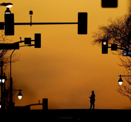 A person rides a hoverboard on a downtown street in Kansas City, Mo. Saturday, March 21, 2020. Officials in Missouri's largest cities are ordering a mandatory stay-at-home rule to residents starting next week in an effort to slow the spread of the coronavirus. St. Louis and St. Louis County authorities first announced the order, which is to begin Monday, before Kansas City officials followed later Saturday with a similar order. The order in Kansas City and surrounding areas is set to begin Tuesday. (AP Photo/Charlie Riedel)