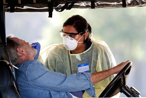 A resident gets tested for coronavirus at a mobile testing site Monday, March 23, 2020, in The Villages, Fla. The Villages, a retirement community, is one of the largest concentration of seniors in the U.S.(AP Photo/John Raoux)