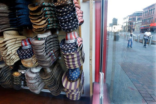 Hats are displayed in a clothing store closed because of the COVID-19 pandemic Tuesday, April 21, 2020, in Nashville, Tenn. Some of Tennessee's biggest cities are not making promises about starting to reopen their economies by Gov. Bill Lee's goal of May 1, saying they are going to let data, not dates, dictate their roll-outs. (AP Photo/Mark Humphrey)