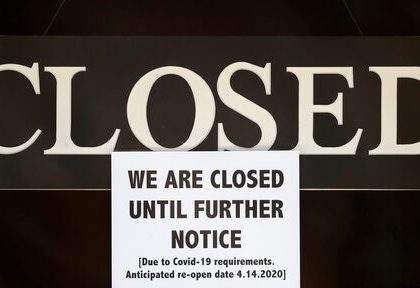 A notice of closure is posted at The Great Frame Up in Grosse Pointe Woods, Mich., Thursday, April 2, 2020. The coronavirus COVID-19 outbreak has triggered a stunning collapse in the U.S. workforce with millions of people losing their jobs in the past two weeks and economists warn unemployment could reach levels not seen since the Depression, as the economic damage from the crisis piles up around the world. (AP Photo/Paul Sancya)