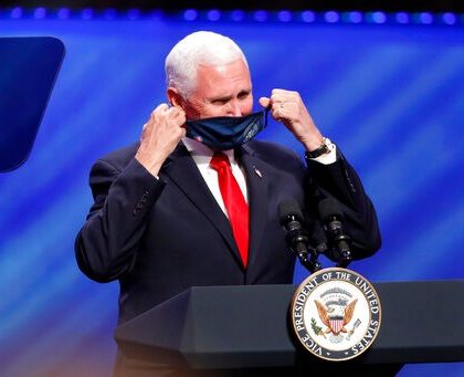 Vice President Mike Pence removes his mask to make comments at First Baptist Church Dallas during a Celebrate Freedom Rally in Dallas, Sunday, June 28, 2020. (AP Photo/Tony Gutierrez)