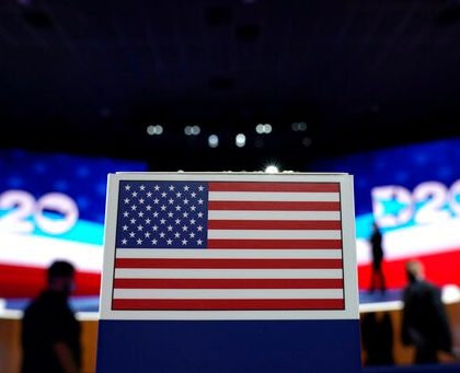 The American flag on top a of state name sign near the stage where Democratic vice presidential candidate Sen. Kamala Harris, D-Calif., will speak on third day of the Democratic National Convention, Wednesday, Aug. 19, 2020, at the Chase Center in Wilmington, Del. (AP Photo/Carolyn Kaster)