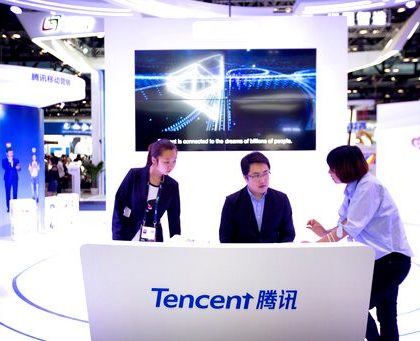 In this April 27, 2017, photo, staff members work at a booth for Chinese technology firm Tencent, makers of the messaging app WeChat, at the Global Mobile Internet Conference (GMIC) in Beijing. President Donald Trump on Thursday, Aug. 6, 2020, ordered a sweeping but unspecified ban on dealings with the Chinese owners of consumer apps TikTok and WeChat, although it remains unclear if he has the legal authority to actually ban the apps from the U.S. (AP Photo/Mark Schiefelbein)