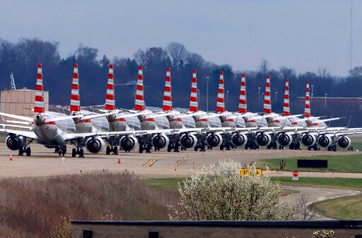 American Airlines planes stored at Pittsburgh International Airport sit idle on a closed taxiway in Imperial, Pa., on Tuesday, March 31, 2020. As airlines cut more service, due to the COVID-19 pandemic, Pittsburgh International Airport has closed one of its four runways to shelter in place 96 planes, mostly from American Airlines, as of Monday, March 30, 2020. The airport has the capacity to store 140 planes. (AP Photo/Gene J. Puskar)