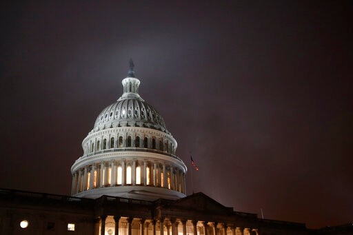 FILE - In this Dec. 9, 2019, file photo mist rolls over the U.S. Capitol dome on Capitol Hill in Washington. On Wednesday, Dec. 11, the Treasury Department releases federal budget data for November. (AP Photo/Patrick Semansky, File)