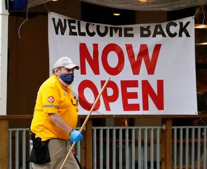 A worker passes a sign at a restaurant along the River Walk that has reopened in San Antonio, Wednesday, May 13, 2020. Many restaurants and stores that were closed due to the COVID-19 pandemic have reopened with some restrictions. (AP Photo/Eric Gay)