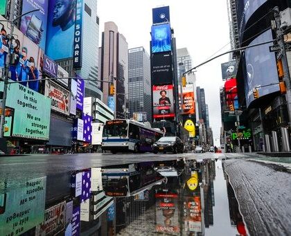 Vehicles move through a nearly empty Times Square during the coronavirus pandemic, Saturday, May 23, 2020, in New York. (AP Photo/Frank Franklin II)
