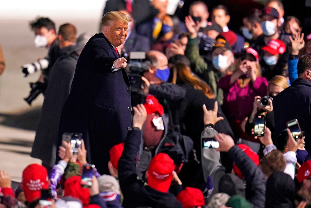 Supporters cheer as President Donald Trump departs following a campaign rally at Erie International Airport, Tom Ridge Field in Erie, Pa, Tuesday, Oct. 20, 2020. (AP Photo/Gene J. Puskar)