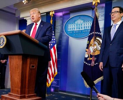 President Donald Trump speaks during a news briefing at the White House, Thursday, July 2, 2020, in Washington, as Treasury Secretary Stephen Mnuchin looks on. (AP Photo/Evan Vucci)